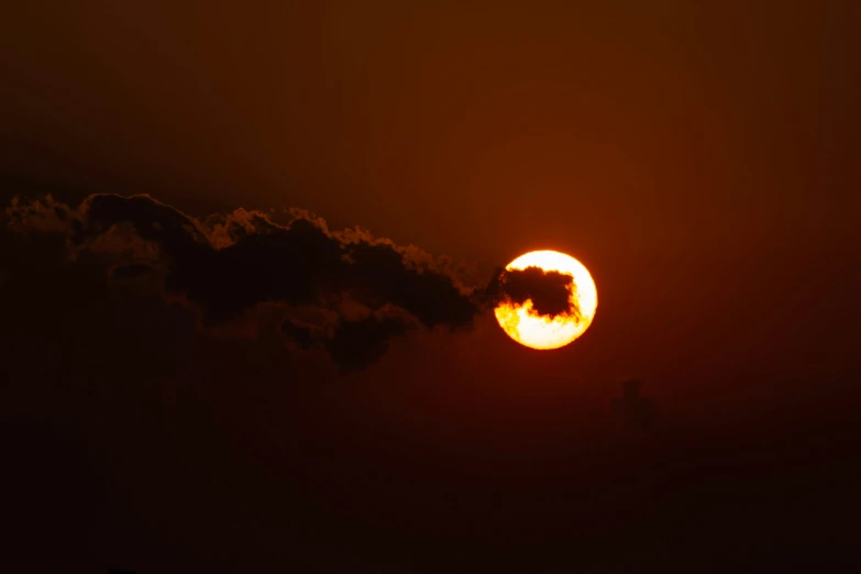 the sun is setting behind a smoke stack, pexels, an eclipse, digital yellow red sun, silhouette :7, paul barson