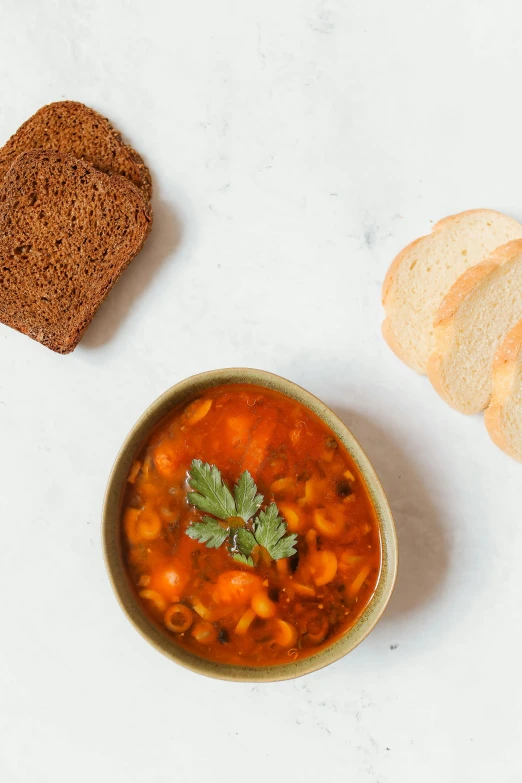 a bowl of soup next to a loaf of bread, by Nicolette Macnamara, high quality product photo, square, jaime jasso, baked beans