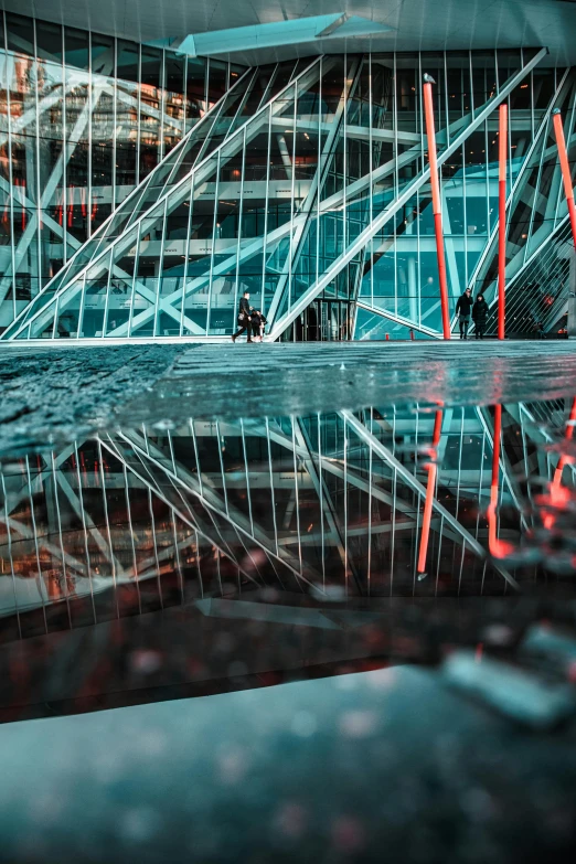 a reflection of a building in a puddle of water, a picture, unsplash contest winner, futurism, red trusses, on a futuristic shopping mall, indoor picture, during the night