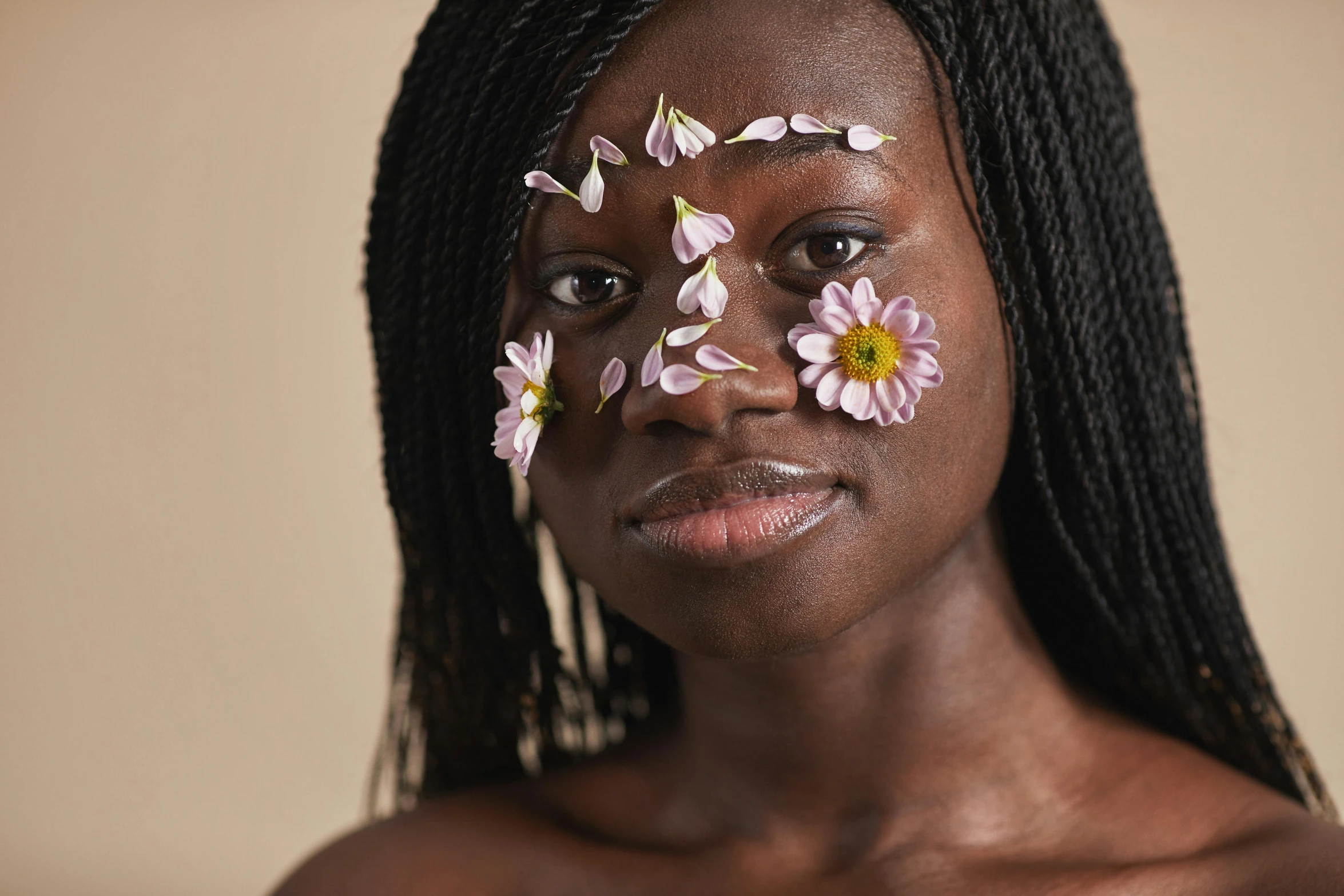 a woman with flowers painted on her face, trending on pexels, hyperrealism, black teenage girl, diffused natural skin glow, on a pale background, photo for a magazine