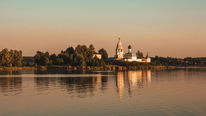 a large body of water with a church in the background, inspired by Konstantin Vasilyev, unsplash contest winner, evening sun, riverside, temple, white