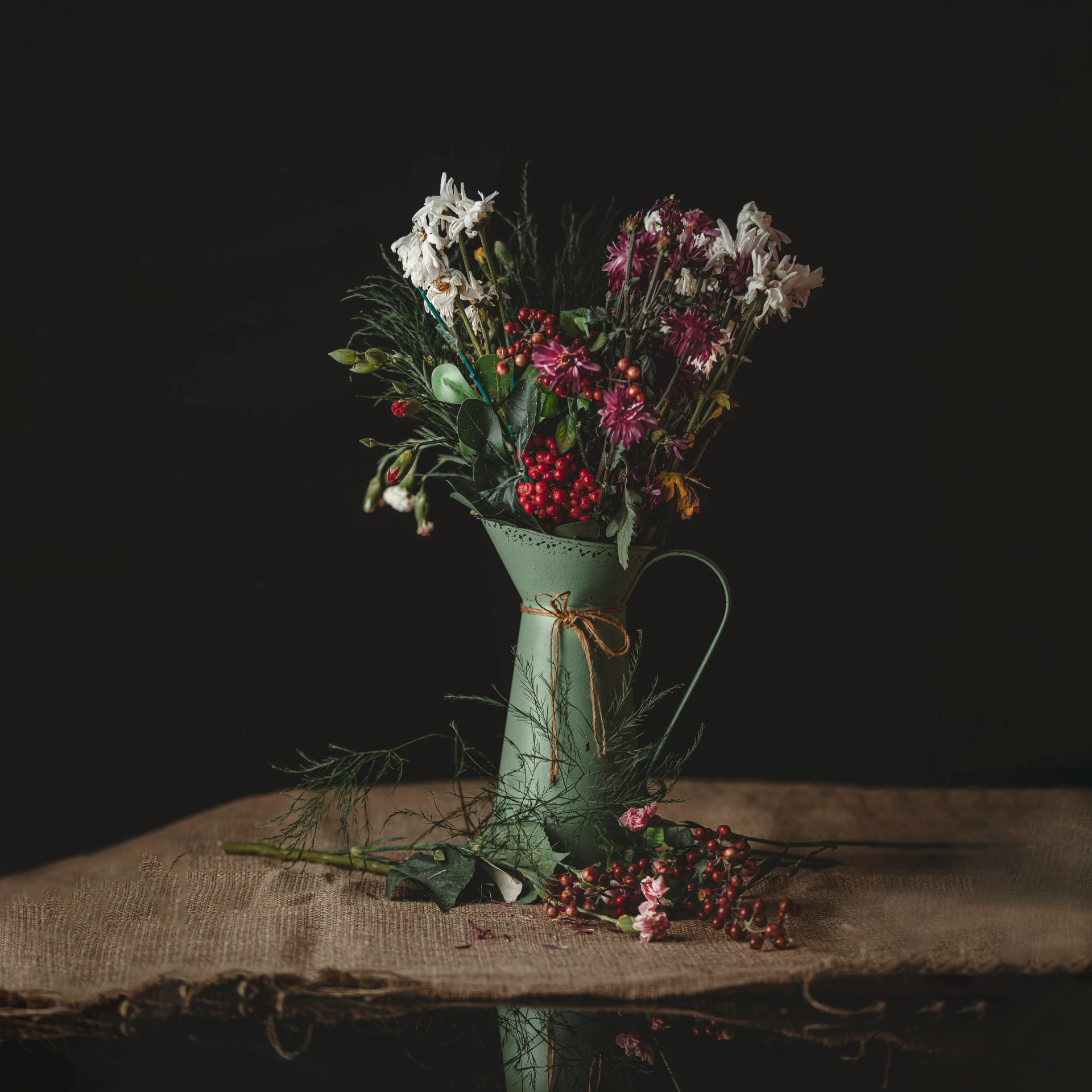 a vase filled with flowers sitting on top of a wooden table, inspired by Elsa Bleda, pexels contest winner, australian tonalism, green and red tones, dressed in a worn, holiday season, various posed