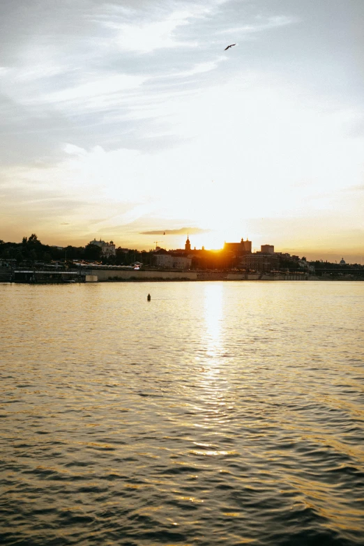 the sun is setting over a body of water, inspired by Wilhelm Marstrand, happening, prague, golden hour 8k, shoreline, yet unrecognizable