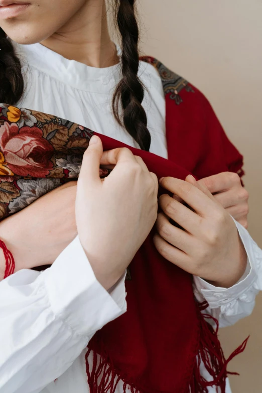 a close up of a person wearing a scarf, an album cover, by Julia Pishtar, romanticism, holding each other hands, ukrainian national clothes, with a kid, repairing the other one