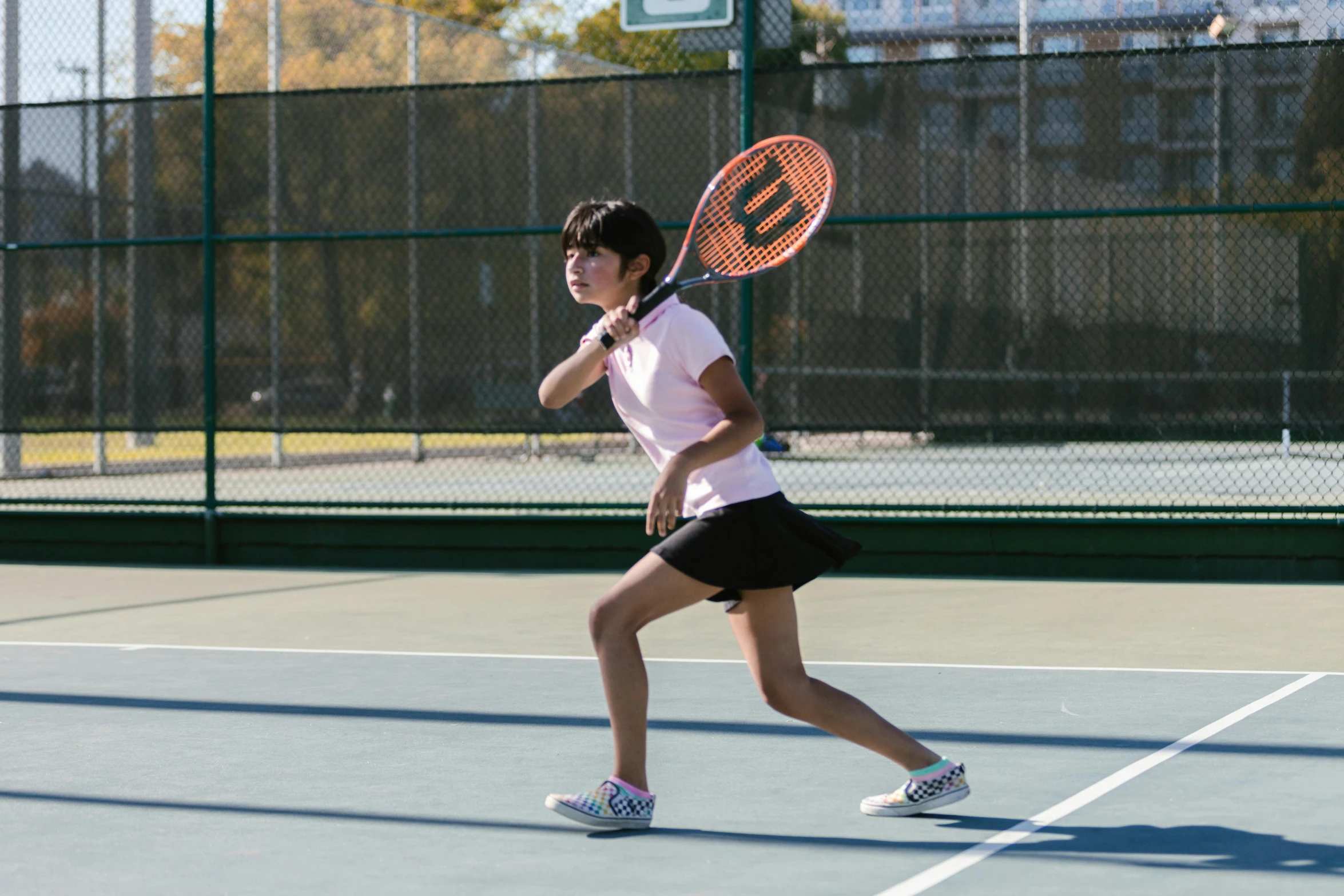 a woman holding a tennis racquet on a tennis court, unsplash, shin hanga, performing, full body image, profile image, aged 13