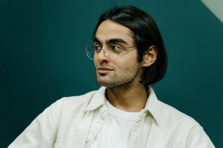 a man wearing glasses and a white shirt, an album cover, by Adam Dario Keel, pexels contest winner, hyperrealism, relaxed eyebrows, sara ali, clear julian lage face, looking from side