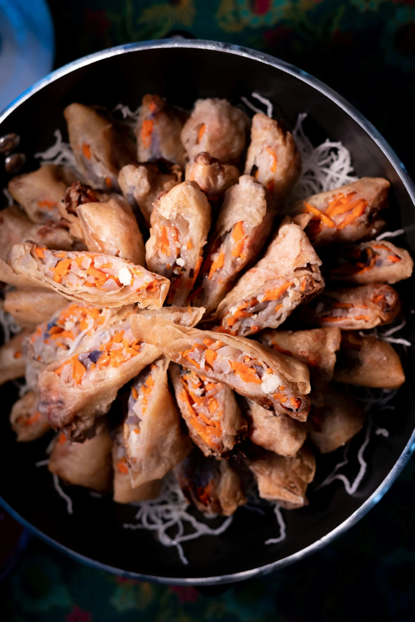 a close up of a bowl of food on a table, with a black background, scrolls, 王琛, cone