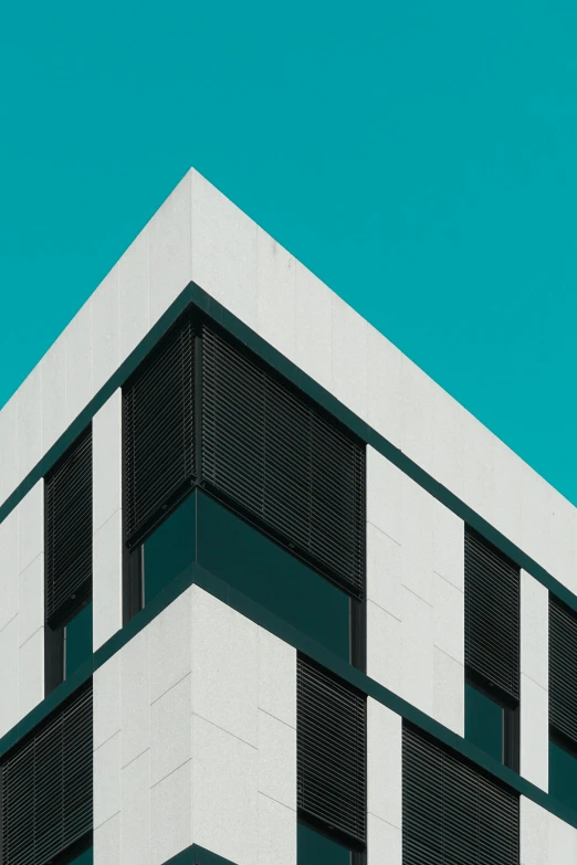 a black and white building against a blue sky, inspired by Bauhaus, unsplash contest winner, white and teal metallic accents, square, healthcare, angled