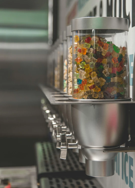 a machine filled with lots of cereal sitting on top of a counter, gummy bears, hibernation capsule close-up, ignant, machina