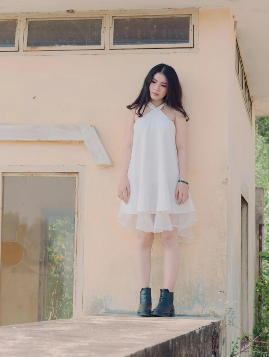 a woman standing on a ledge in front of a building, by Tan Ting-pho, wearing a cute white dress, model エリサヘス s from acquamodels, ((portrait)), translucent