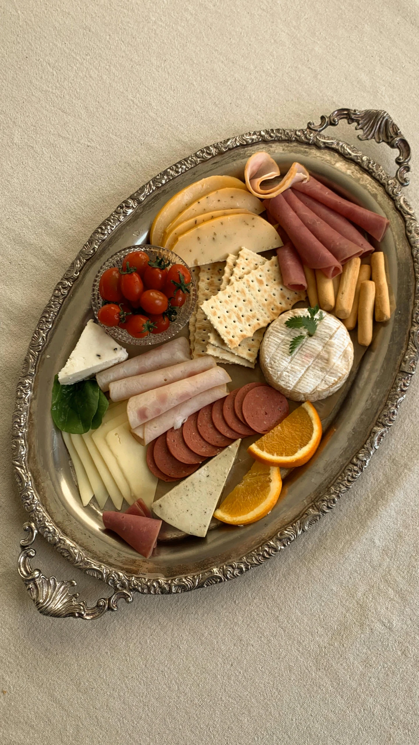 a platter of food sitting on top of a table, by Kristin Nelson, renaissance, silver，ivory, cheese and pepperoni, vintage associated press photo, high view