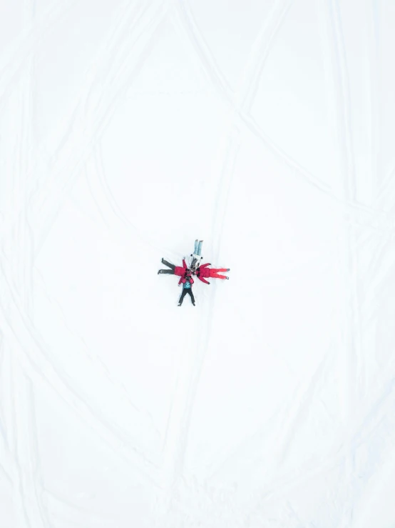 a person riding skis down a snow covered slope, an album cover, unsplash, postminimalism, white splendid fabric, that looks like a insect, seen from straight above, white red