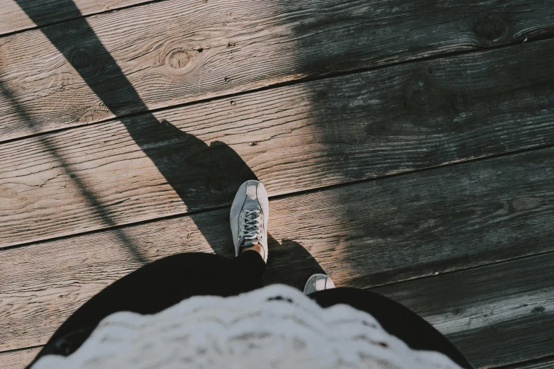 a person standing on top of a wooden floor, trending on pexels, soft shadow, background image, whole shoe is in picture, childhood friend vibes