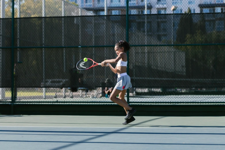 a woman swinging a tennis racquet on a tennis court, unsplash, arabesque, san francisco, kids, taken with canon 5d mk4, cornell