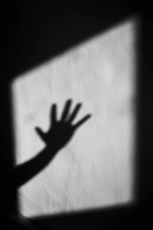 a shadow of a hand reaching out of a window, a black and white photo, inspired by Katia Chausheva, unsplash, square, scream, crime, shadow people