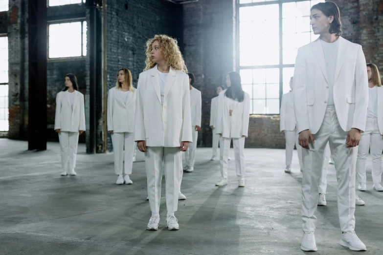 a group of people in white suits standing in a room, inspired by Vanessa Beecroft, antipodeans, curly blonde hair | d & d, wearing a tracksuit, in formation, heilung