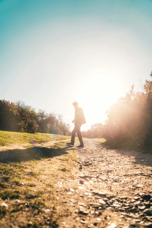 a man riding a skateboard down a dirt road, a picture, by Niko Henrichon, unsplash, overexposed sunlight, stepping stones, a woman walking, 15081959 21121991 01012000 4k