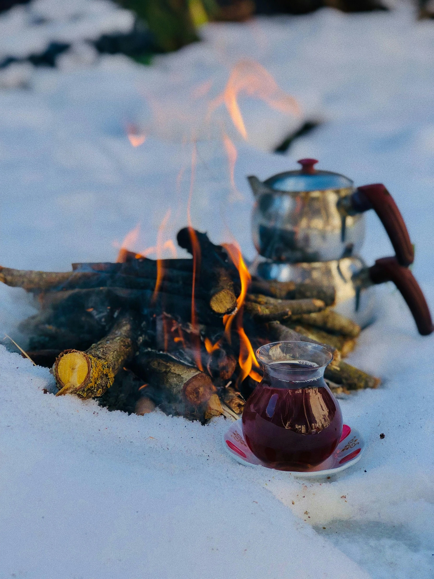 a tea pot sitting on top of a fire in the snow, maroon, profile image, food, brown