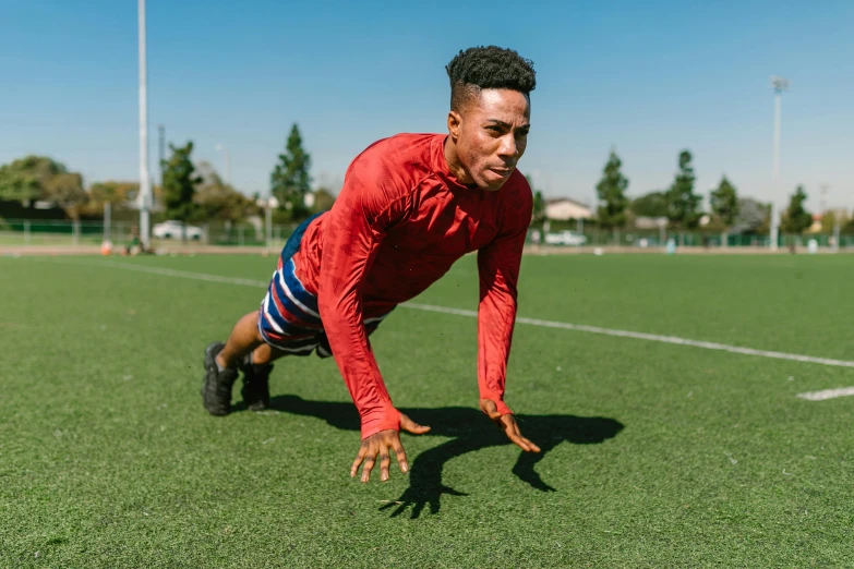 a man doing push ups on a soccer field, pexels contest winner, alexis franklin, broad shoulders, 15081959 21121991 01012000 4k, outside on the ground