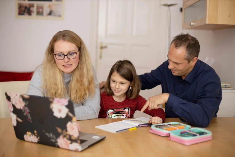 a man and woman sitting at a table with a little girl, pexels contest winner, danube school, in front of a computer, avatar image, high quality picture, thomas reimann