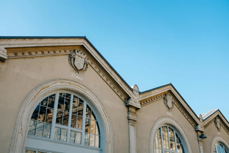 a clock that is on the side of a building, pexels contest winner, paris school, high arched ceiling, profile image, facing front, shop front