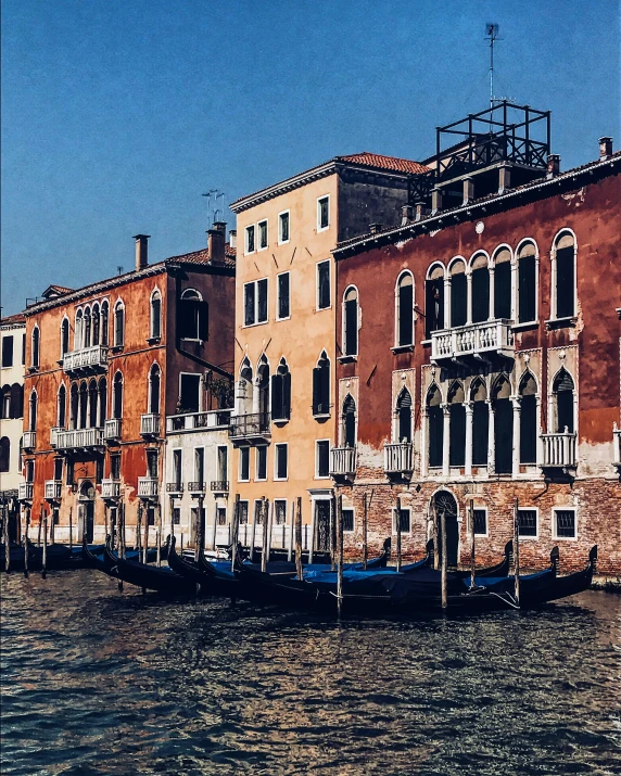 a row of buildings next to a body of water, an album cover, by Canaletto, pexels contest winner, red brown and blue color scheme, gif, gondola, low quality grainy