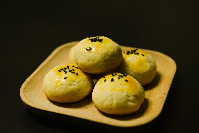 a close up of a plate of food on a table, sexy sesame seed buns, 千 葉 雄 大, black and yellow, square