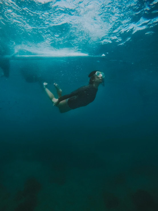 a man swimming next to a whale in the ocean, by Jessie Algie, pexels contest winner, happening, portrait of a woman underwater, floating. greenish blue, ( ( ( kauai ) ) ), diving suit
