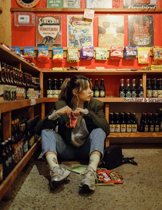 a woman sitting on the floor in a store, by Jan Tengnagel, pexels contest winner, cinematic beer, snacks, 🍸🍋, profile image