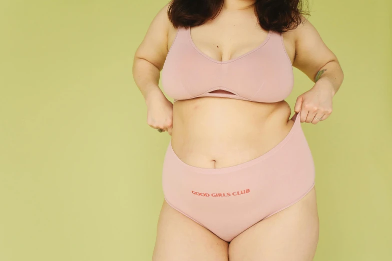a woman in a pink underwear posing for a picture, trending on pexels, slightly overweight, thick outlines, pierced navel, bbwchan