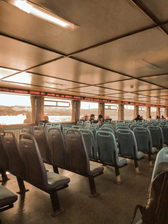 a group of people sitting on top of a boat, interior of staten island ferry, iceland photography, buses, 🚿🗝📝