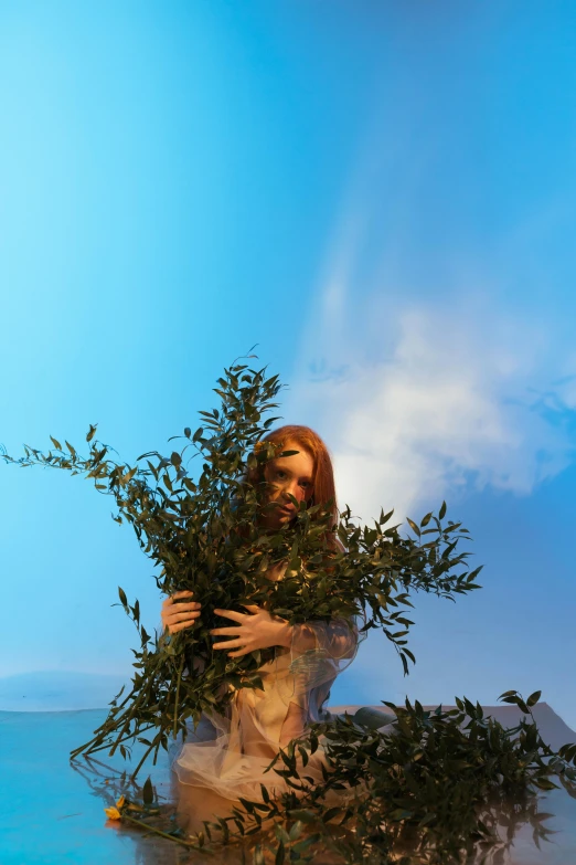 a woman standing in the water holding a plant, a surrealist sculpture, inspired by Pierre Puvis de Chavannes, unsplash, fantastic realism, wax figure, olive tree, maiden with copper hair, skies