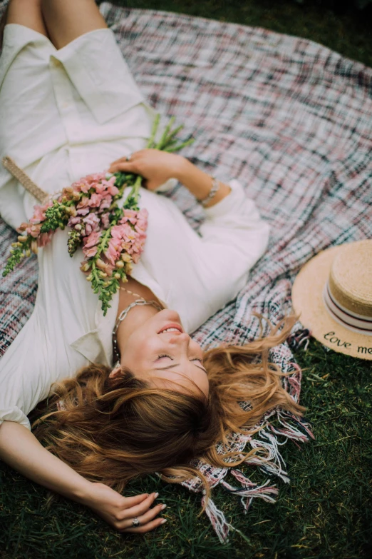 a woman laying on a blanket in the grass, pexels contest winner, romanticism, bouquet, 15081959 21121991 01012000 4k, midsommar color theme, made of flowers