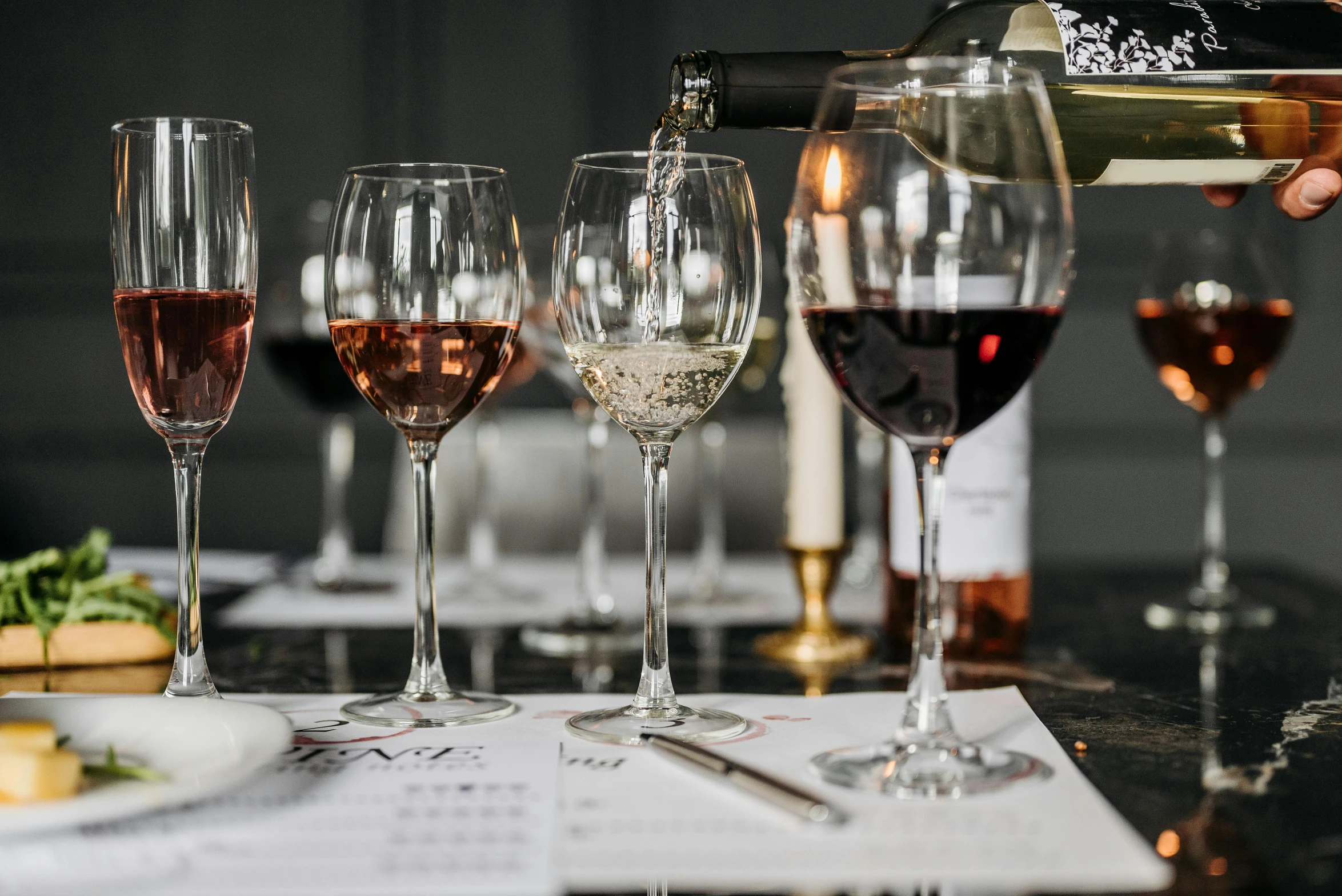 a group of wine glasses sitting on top of a table, pexels contest winner, private press, pouring, payne's grey and venetian red, chefs table, david bates