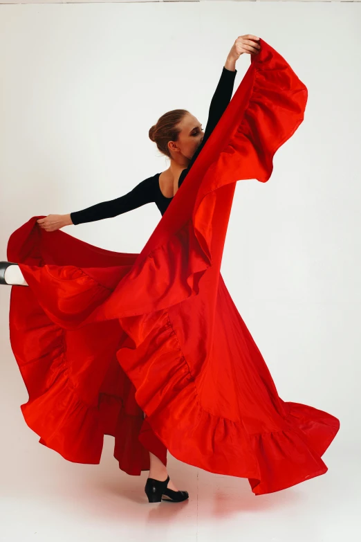 a woman in a red dress is dancing, pexels contest winner, arabesque, mario testino, wearing a long flowy fabric, gif, promotional image