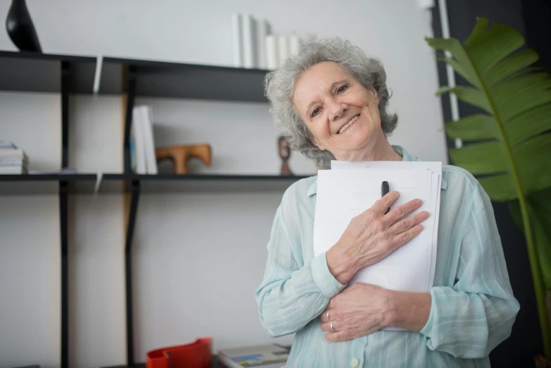 a woman holding a piece of paper in her hands, a portrait, pexels contest winner, portrait of hide the pain harold, holding books, health supporter, head to waist