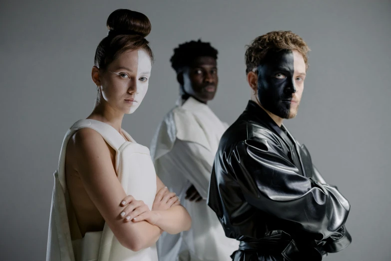 a group of people standing next to each other, pexels contest winner, renaissance, futuristic fashion show, white and black, black face, rule of three