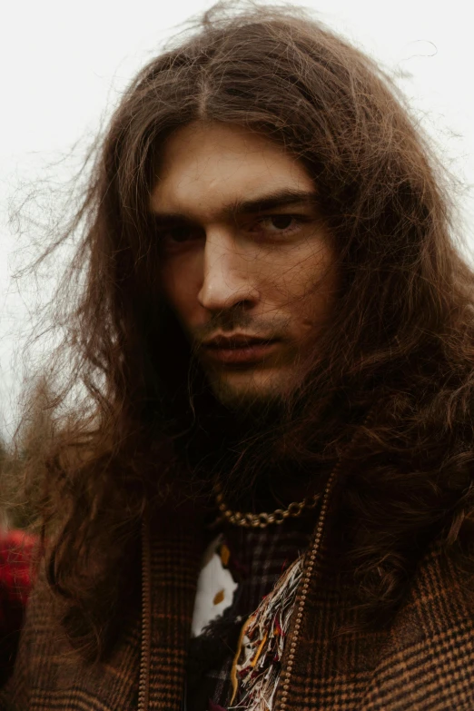 a close up of a person with long hair, an album cover, inspired by Cornelis de Man, male model, dressed in a ((ragged)), hair : long brown, slide show