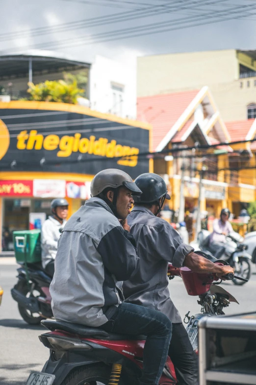 a couple of people riding on the back of a motorcycle, trading depots, golden detailing, yellow helmet, 🚿🗝📝