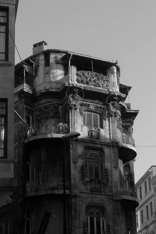 a black and white photo of a tall building, by Altichiero, flickr, art nouveau, fallout style istanbul, old abandoned house, street corner, ornate hair