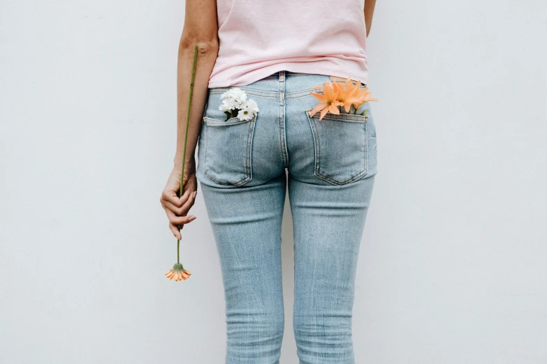 a woman with a flower in her back pocket, inspired by Sarah Lucas, trending on unsplash, minimalism, fan favorite, edible flowers, with a bunch of stuff, thigh gap