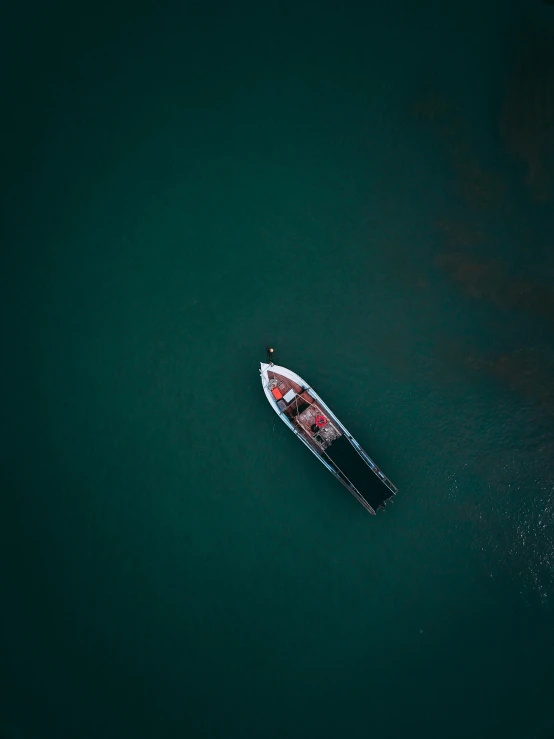 a small boat floating on top of a body of water, looking down on the camera, cinematic 4 k wallpaper, multiple stories, deep colours. ”