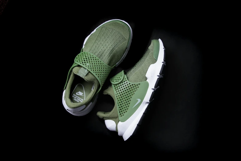 a pair of green sneakers on a black surface, mini model, pods, nike, prettt