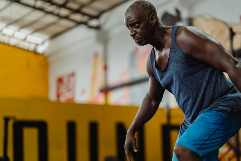 a man playing a game of frisbee in a gym, a portrait, pexels contest winner, lance reddick, very sweaty, promo image, background image