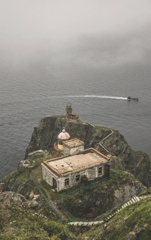 a small building sitting on top of a cliff next to a body of water, by Matteo Pérez, lighthouse, mexico, low quality photo, thumbnail