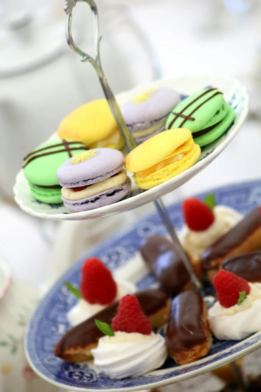 a close up of a plate of food on a table, eating cakes, complimentary colours, tea party, square