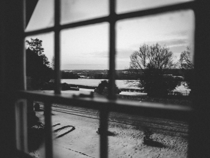 a view of a river through a window, inspired by Bert Hardy, snow outside the windows, 35mm film photo, conor walton, uploaded