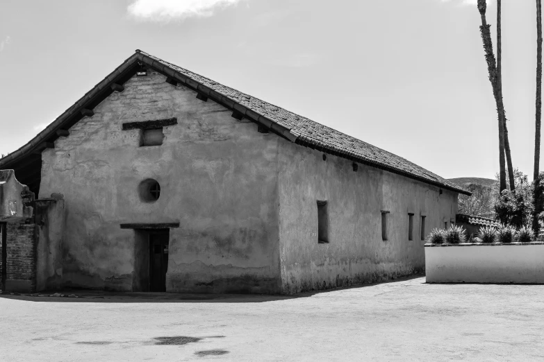 a black and white photo of an old building, inspired by Dorothea Lange, pexels contest winner, renaissance, rammed earth courtyard, napa, background image, in chuquicamata