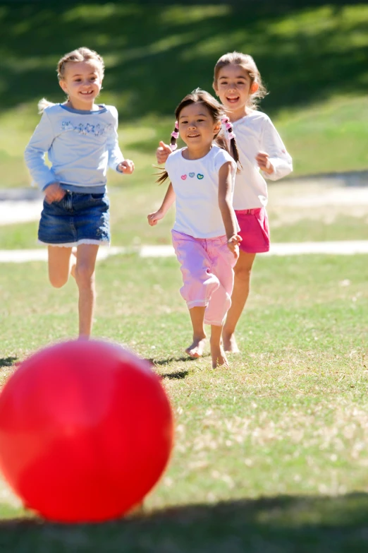 a group of children running towards a red ball, casual playrix games, sydney park, precious moments, soft
