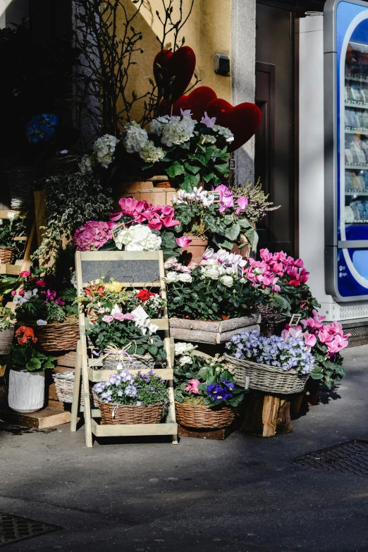 a woman standing in front of a flower shop, by Niko Henrichon, trending on unsplash, romanticism, wooden crates, hydrangea, streetscape, piled around
